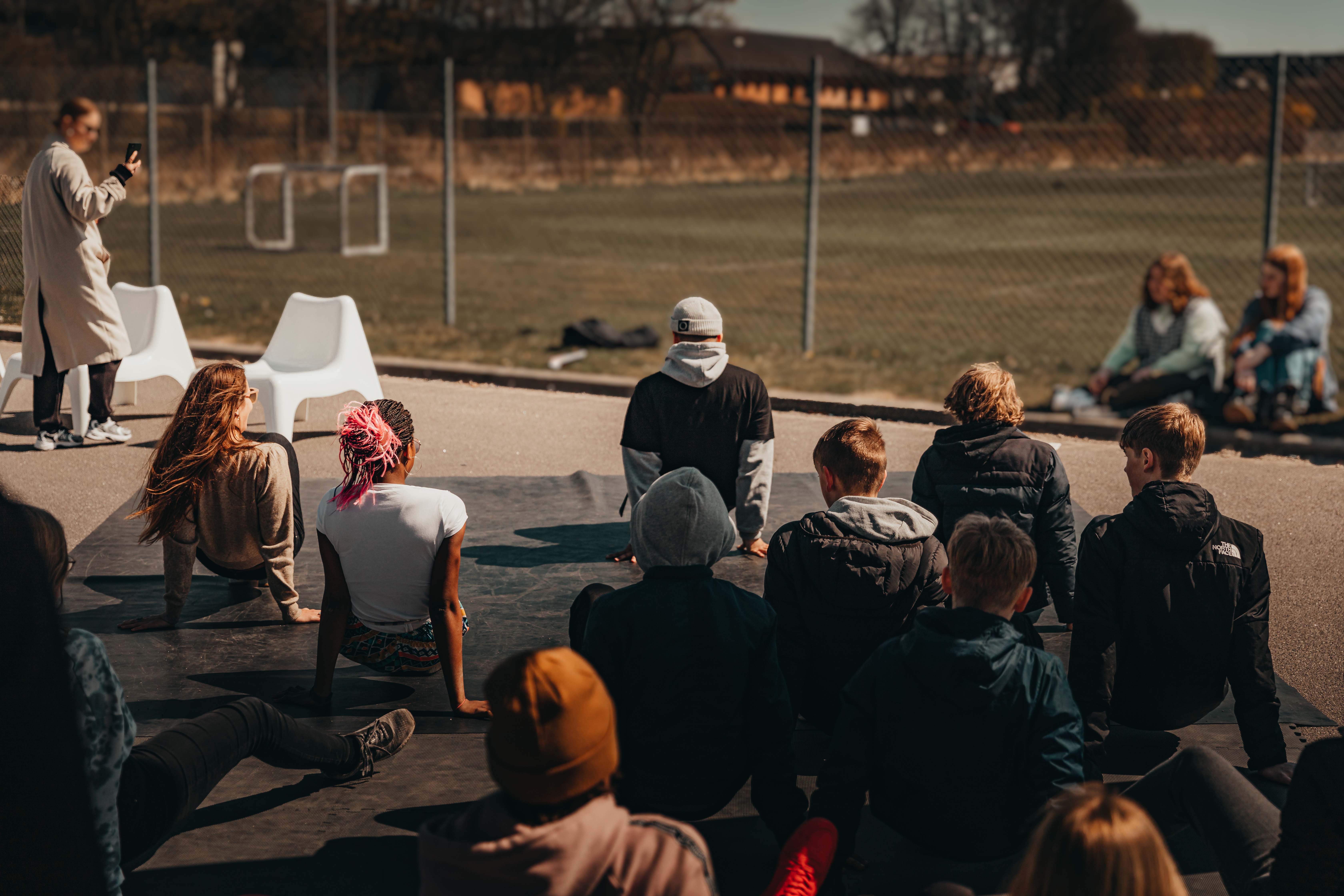 People seeming to be stretching viewed from the back