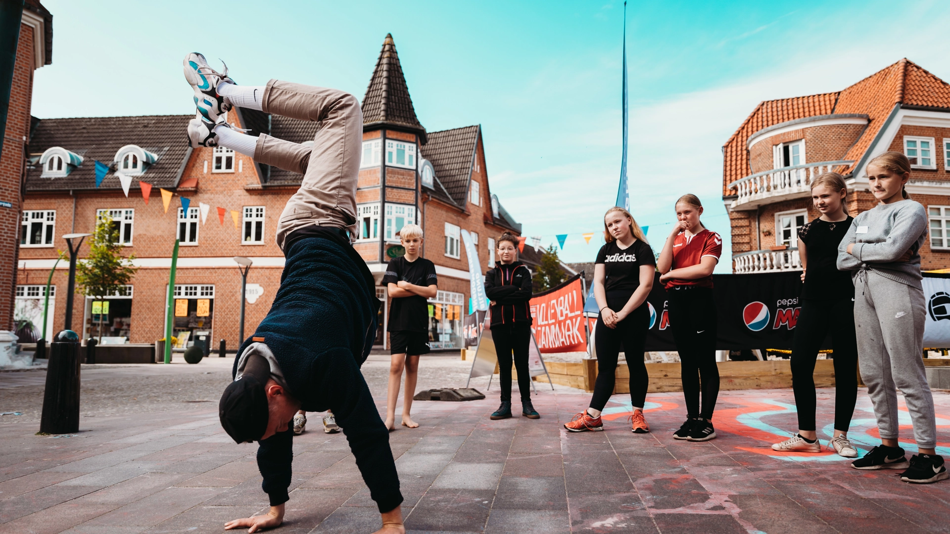 Person doing a handstand while people are watching them